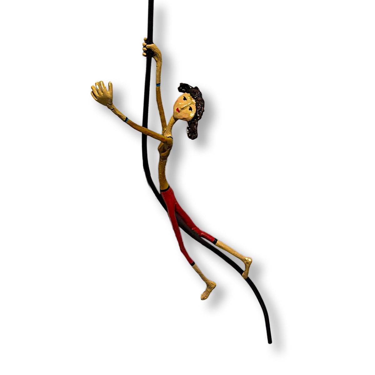 Minimalist sculpture of two figures on and hanging from a large red balloon. (view 3)