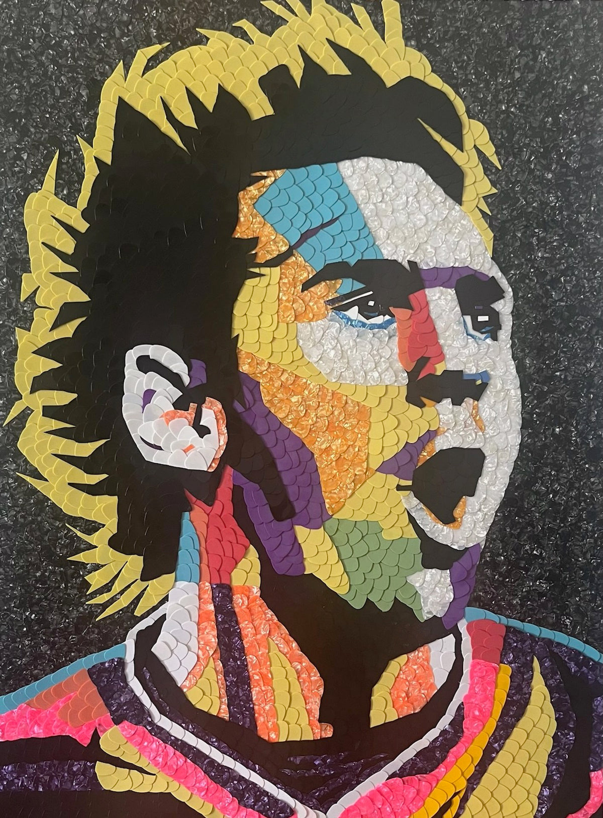 Mosaic portrait evoking Lionel Messi made from colorful guitar picks.