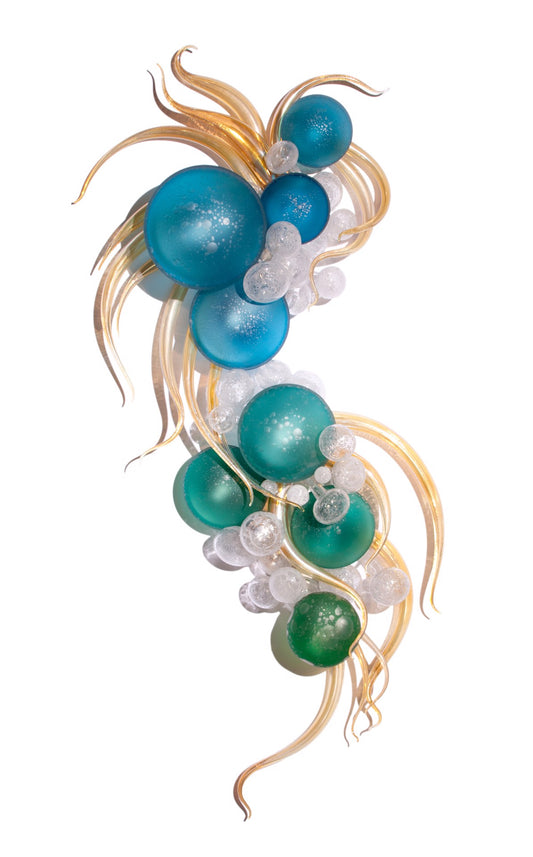 Wall sculpture of blue and green glass bubbles with gold, wavy accents on a white background.