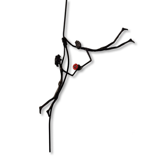 Minimalist sculpture of a stick figure floating while holding a red balloon. (view 2)