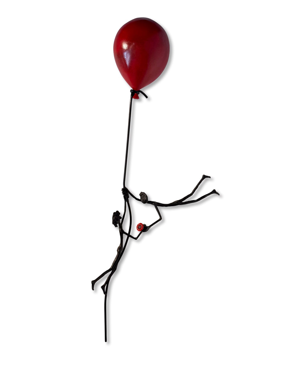 Minimalist sculpture of a stick figure floating while holding a red balloon.