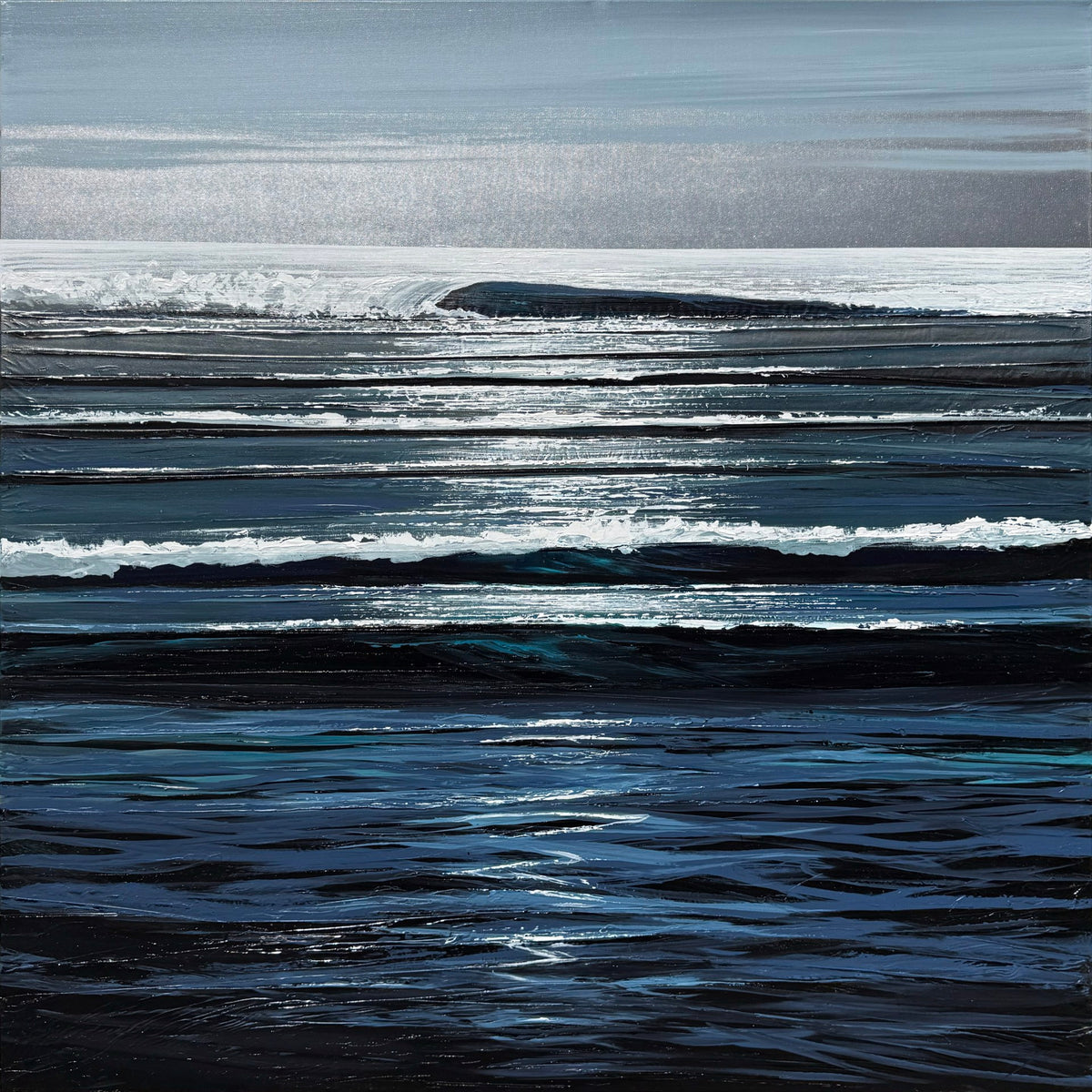 A calm ocean scene with gentle waves reflecting sunlight under a mostly cloudy sky.