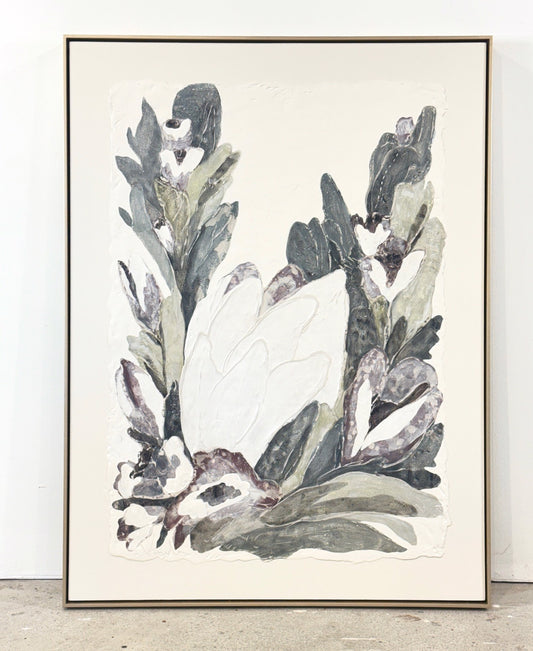 Framed abstract painting of a large white flower among green and purple leaves.
