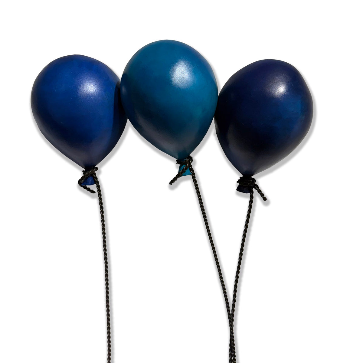 Metal sculpture of two figures on a bench lifted by three blue balloons. (view 3)