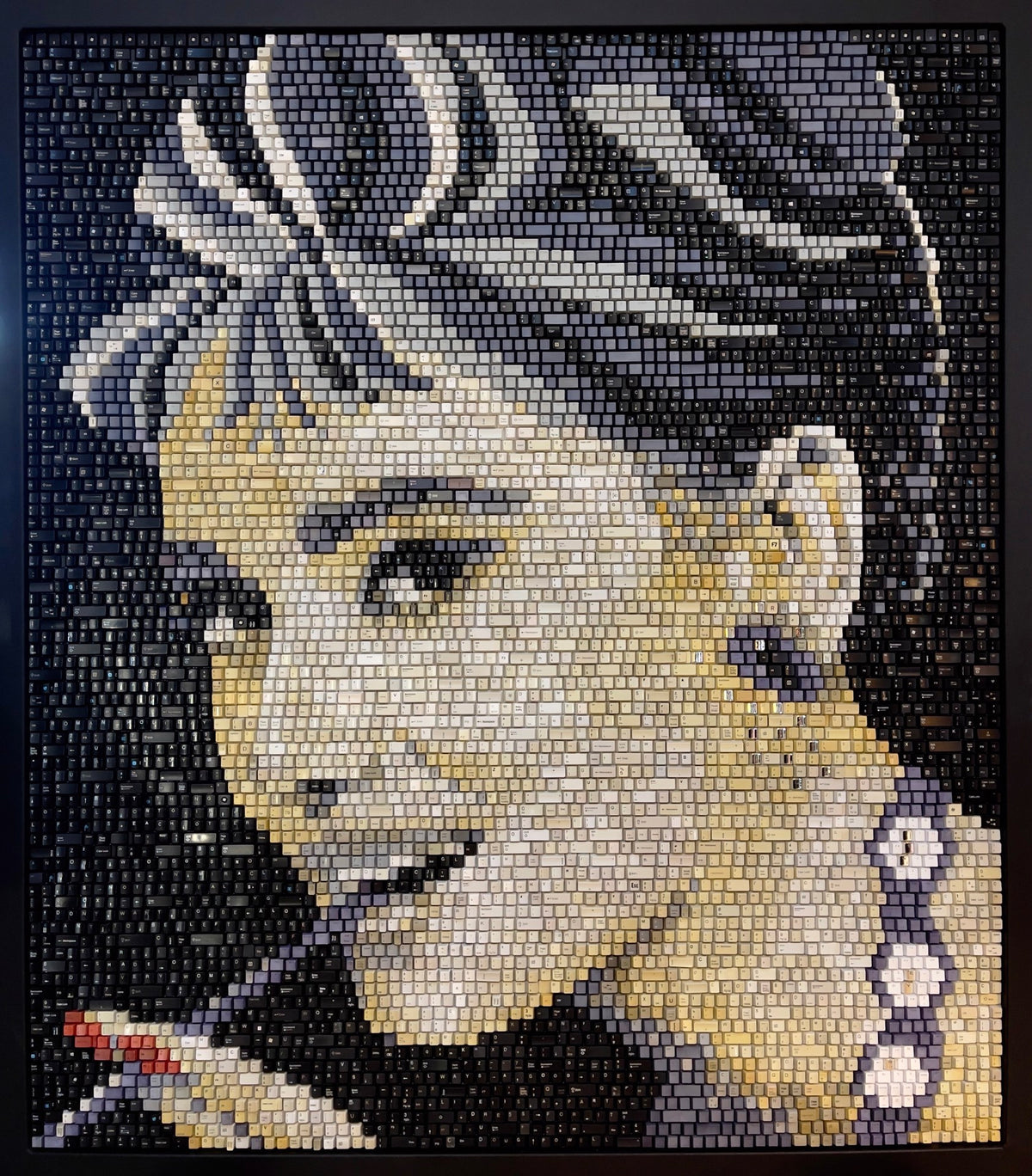 A mosaic portrait of Audrey Hepburn made of upcycled keyboard keys.