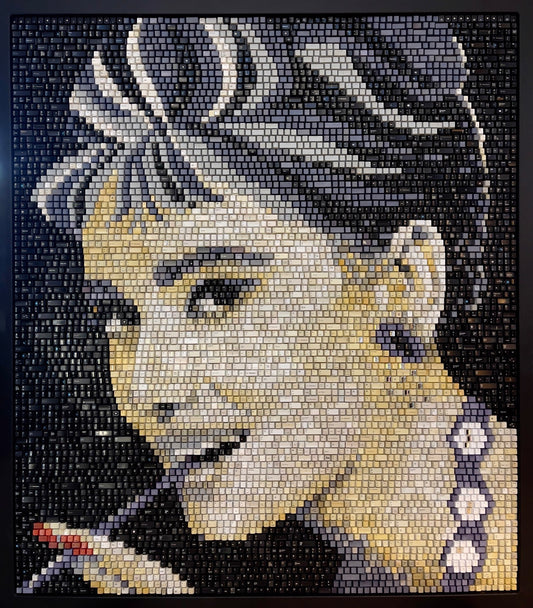 A mosaic portrait of Audrey Hepburn made of upcycled keyboard keys.