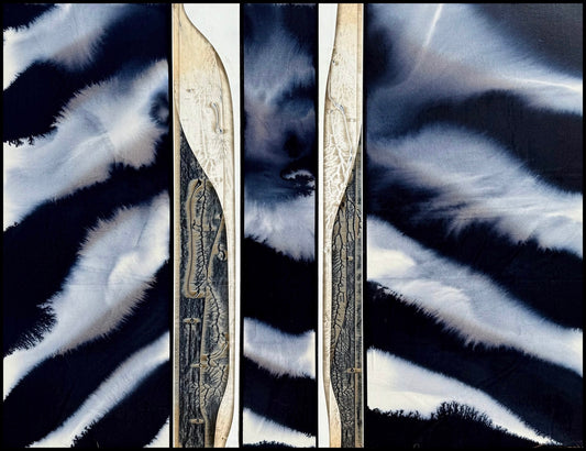 Abstract triptych of dark wavy patterns with light streaks and etched designs on wood.