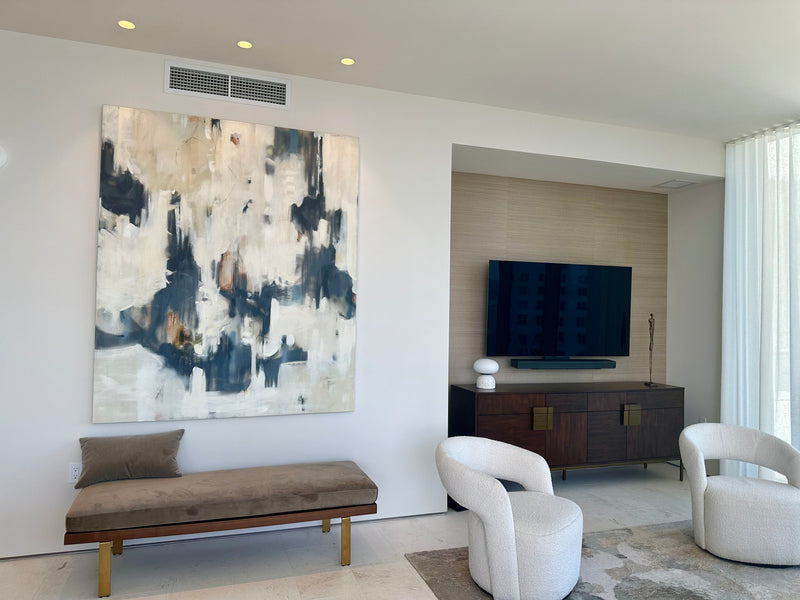 Dixie Purvis navy, cream and gold abstract painting above a velvet bench in a contemporary condo living room