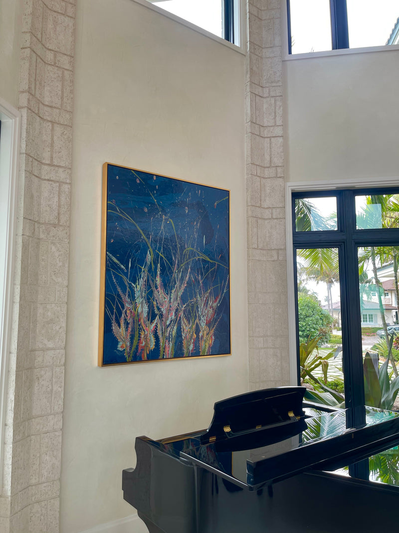 Ann Griffith's deep blue botanical painting of wild grasses beside a staircase above a grand piano, South Florida home