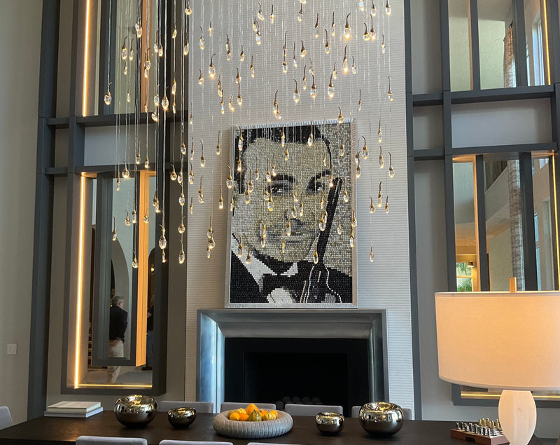 Doug Powell black and white portrait of a man in a tuxedo made from recycled keys, above a modern fireplace