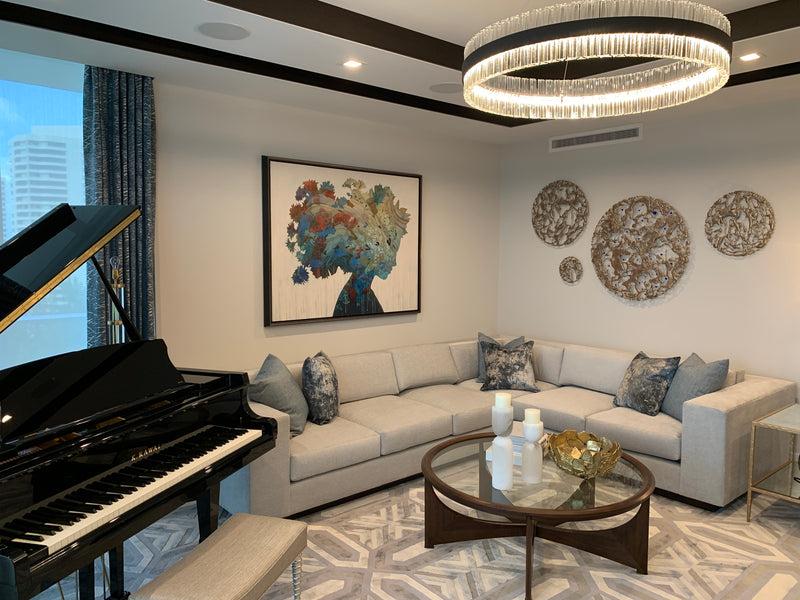 Christopher Peter painting of a woman with a floral head and round Jennyfer Stratman wall sculptures, piano room