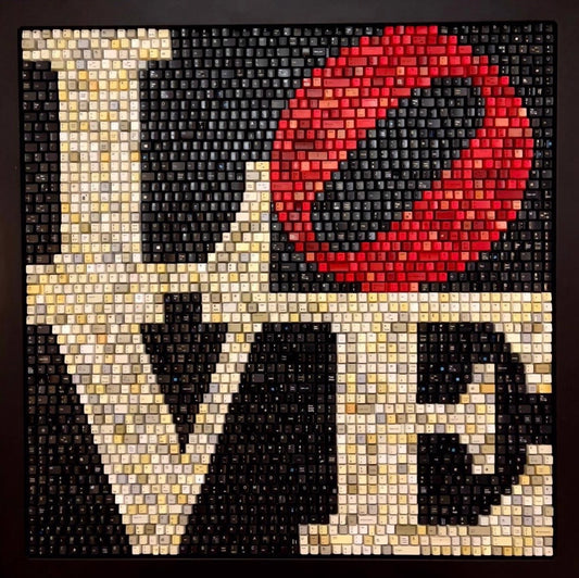 LOVE spelled out using small colored cubes, with a red tilted "O".