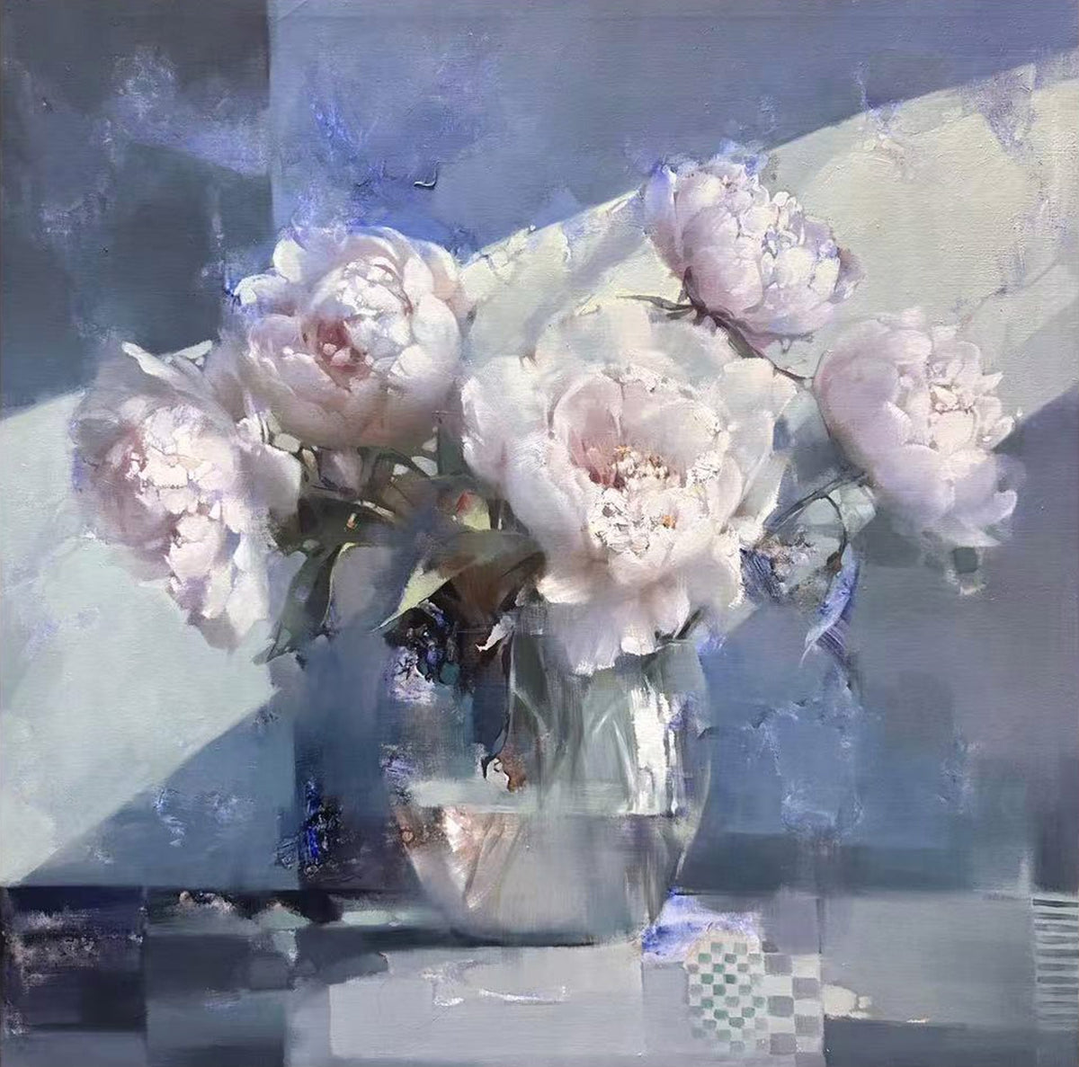 White peonies in a glass vase with light streaming across a checkered table.